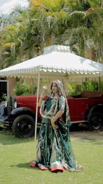 Royal shoot with vintage red car and canopy tent on lush castle lawns