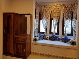 Executive Room arched window bay daybed with wooden wardrobe