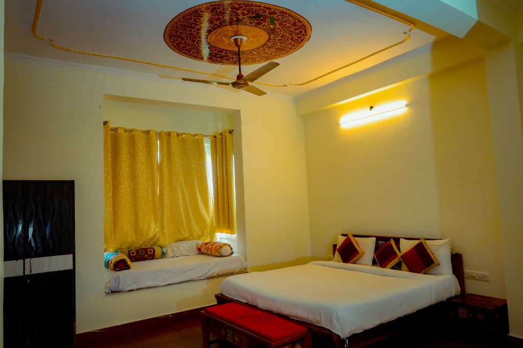 Family Deluxe Room king bed with traditional ceiling medallion