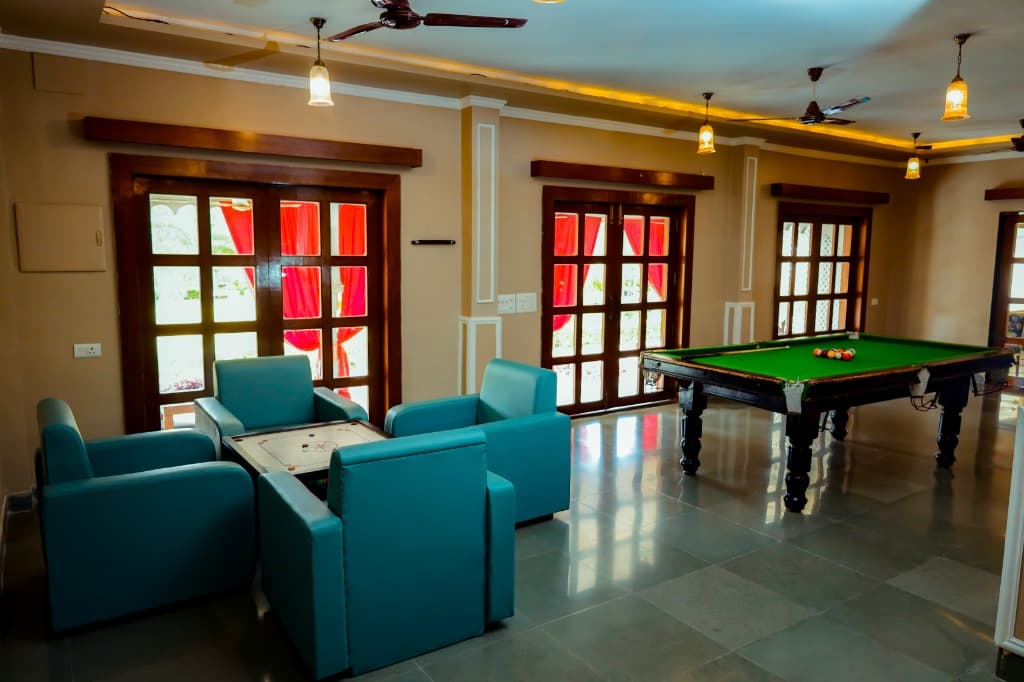 Royal indoor game lounge with billiards snooker table and carrom seating lounge